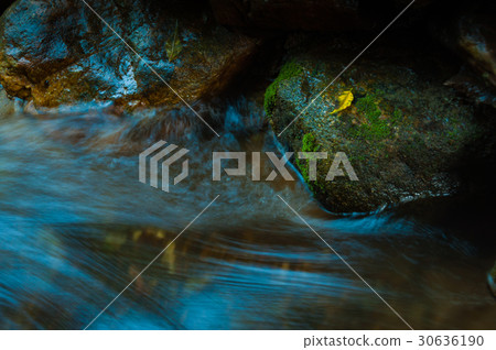 Waterfall and rocks with leaf in dark low key Waterfall and rocks with leaf in dark low key 30636190