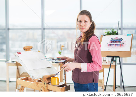 Portrait of a young woman painter drawing with 30636657