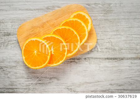 Slices of fresh oranges on white wood background Slices of fresh oranges on white wood background 30637619