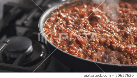 roasting minced beef with tomato paste in a pan roasting minced beef with tomato paste in a pan 30637620