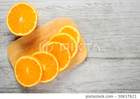 Slices of fresh oranges on white wood background 30637621