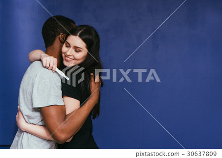 Pregnancy test, positive. Happy future parents hug 30637809