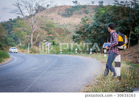 Tourists man walk along mountain roads. 30638163