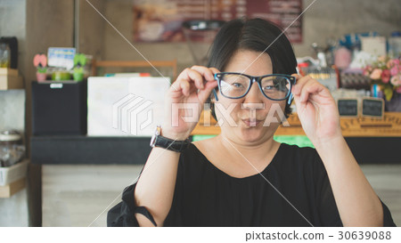 Asia women with eye glasses in coffee shop Asia women with eye glasses in coffee shop 30639088