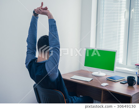 office worker sitting at computer with Chromakey 30649130