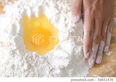 Pouring egg yolk mixing with flour,bread cooking Pouring egg yolk mixing with flour,bread cooking 30651476