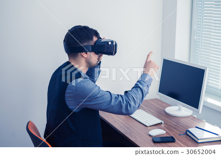 Young businessman in vr glasses drawing chart with 30652004
