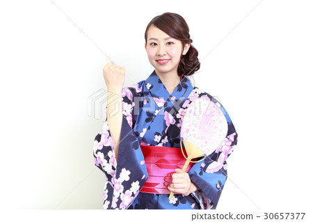 Young women in a yukata taking a guts pose Young women in a yukata taking a guts pose 30657377