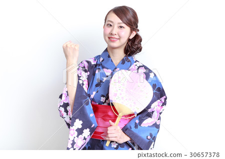 Young women in a yukata taking a guts pose Young women in a yukata taking a guts pose 30657378