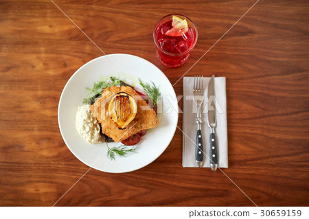 close up of fish salad with roasted lemon on plate 30659159