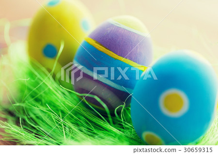 close up of colored easter eggs and grass close up of colored easter eggs and grass 30659315