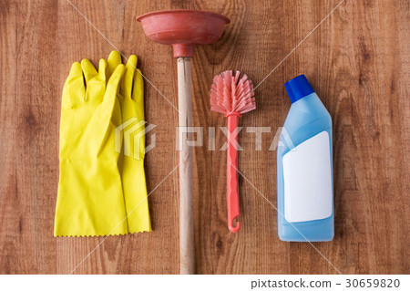 plunger with cleaning stuff on wooden background 30659820