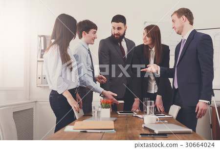 Business meeting. Young team in modern office Business meeting. Young team in modern office 30664024