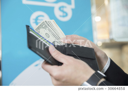 Businessman who changes currency at money exchange office hand Businessman who changes currency at money exchange office hand 30664858