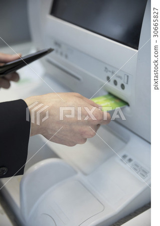 Businessman withdrawing cash at ATM handy hand Businessman withdrawing cash at ATM handy hand 30665827