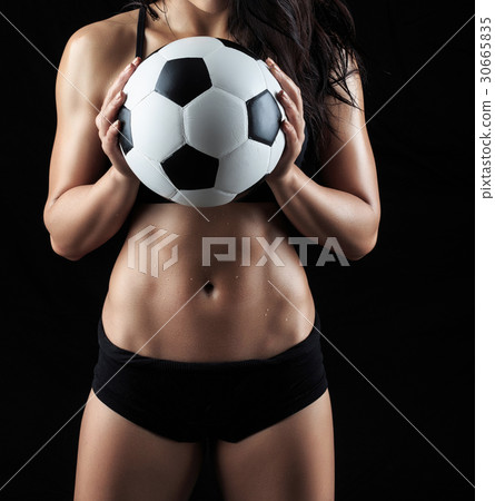 Beautiful body of fitness model holding soccer ball 30665835