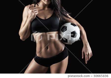 Beautiful body of fitness model holding soccer ball 30665836