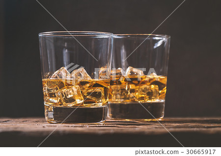 Whiskey with ice in glasses Whiskey with ice in glasses 30665917