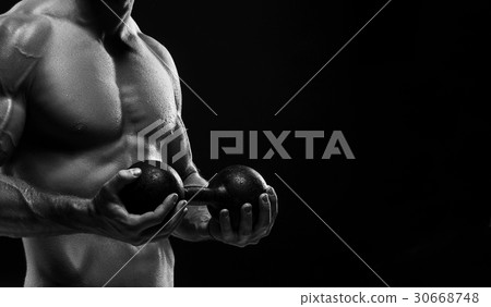 The torso of attractive male body builder on black The torso of attractive male body builder on black 30668748