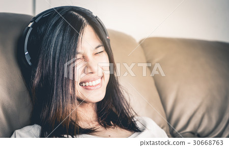 girl is laugh and smiling while listening to Music 30668763