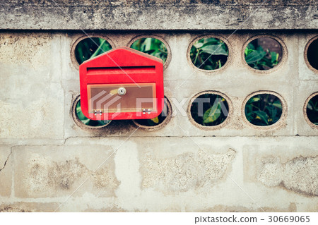 Close up red mail box on cement wall 30669065