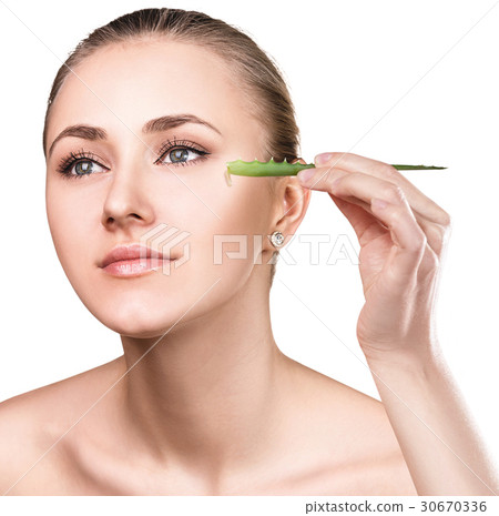 Young woman uses aloe vera oil for skin. 30670336