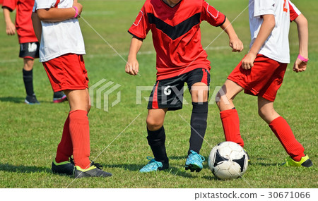 Young kids in action at the soccer match 30671066