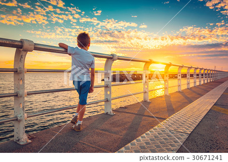 Boy watching sunset from St. Kilda Jetty 30671241