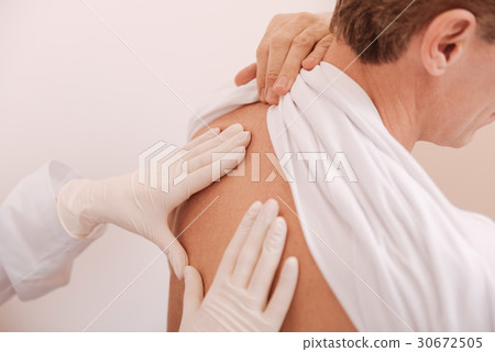 Helpful nice patient holding his shirt up Helpful nice patient holding his shirt up 30672505