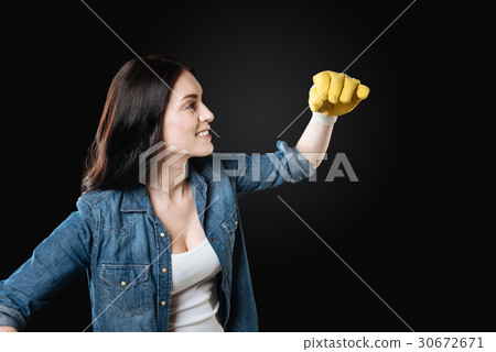 Positive delighted brunette looking at her hand 30672671