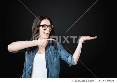 Joyful girl keeping smile on her face 30673606