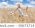 Happy Young woman in a wheat field 30673714