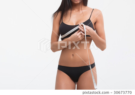 Young beautiful girl measures your body parts of Young beautiful girl measures your body parts of 30673770