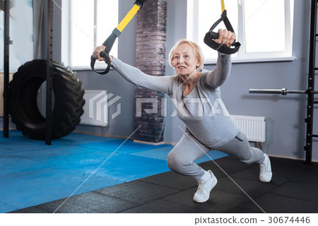 Pleasant well built woman visiting a gym Pleasant well built woman visiting a gym 30674446
