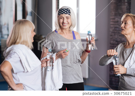 Joyful retired women talking to each other Joyful retired women talking to each other 30675021