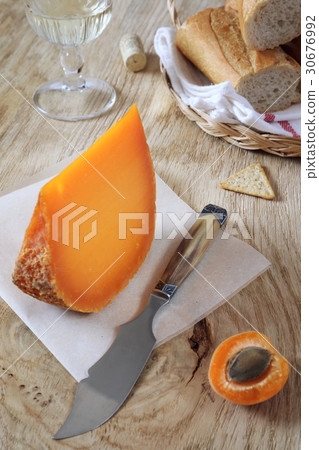 Mimolette cheese, baguette and wineglass Mimolette cheese, baguette and wineglass 30676992