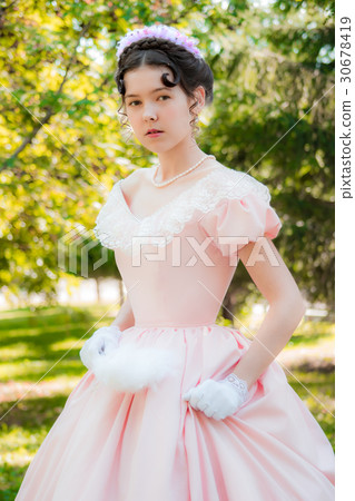 Girl in evening dress in a hurry for a meeting. 30678419
