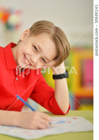 Cute boy drawing with pencils 30680141