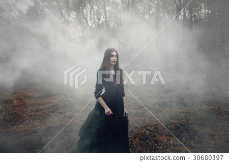 Young attractive Witch walking on the field Young attractive Witch walking on the field 30680397