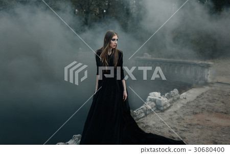 Young attractive Witch walking on the bridge Young attractive Witch walking on the bridge 30680400