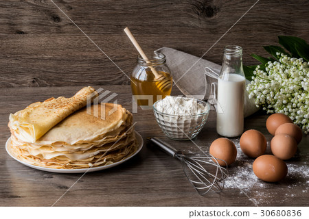 Delicious pancakes on wooden table Delicious pancakes on wooden table 30680836