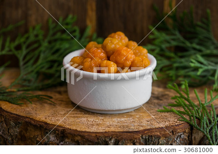 Pickled Cloudberries in a sweet syrup in a white Pickled Cloudberries in a sweet syrup in a white 30681000