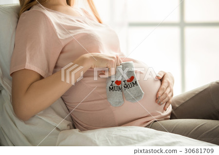 Young preganant woman expecting a baby relaxing on 30681709