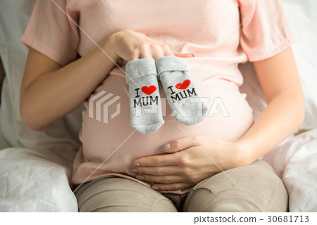 Young preganant woman expecting a baby relaxing on 30681713