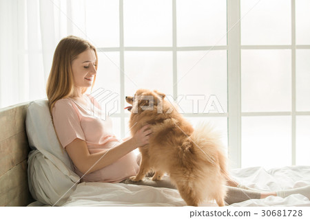 Young preganant woman expecting a baby relaxing on 30681728