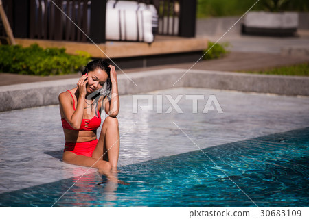 Attractive woman talking on her mobile phone by 30683109