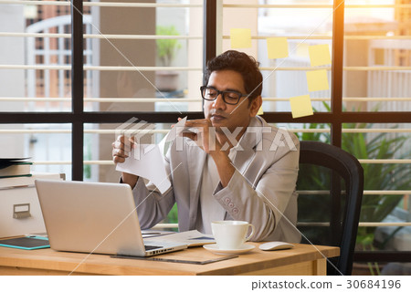 indian male typing resignation letter 30684196