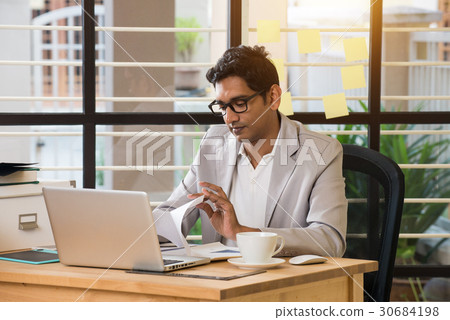 indian male typing resignation letter 30684198