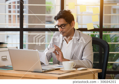 indian male typing resignation letter 30684201