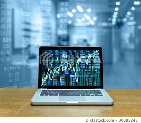 Stock exchange market trading graph over the screen of computer laptop on wood table over the photo blurred of trading graph background, business marketing trade concept Stock exchange market trading graph over the screen of computer laptop on wood table over the photo blurred of trading graph background, business marketing trade concept 30685248